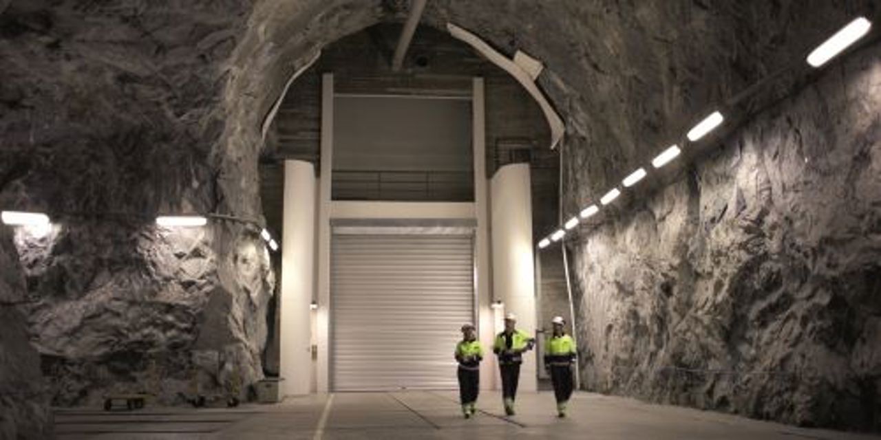 Three workers walking in tunnel