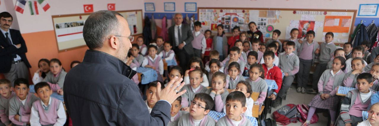 Man teaching a class of children