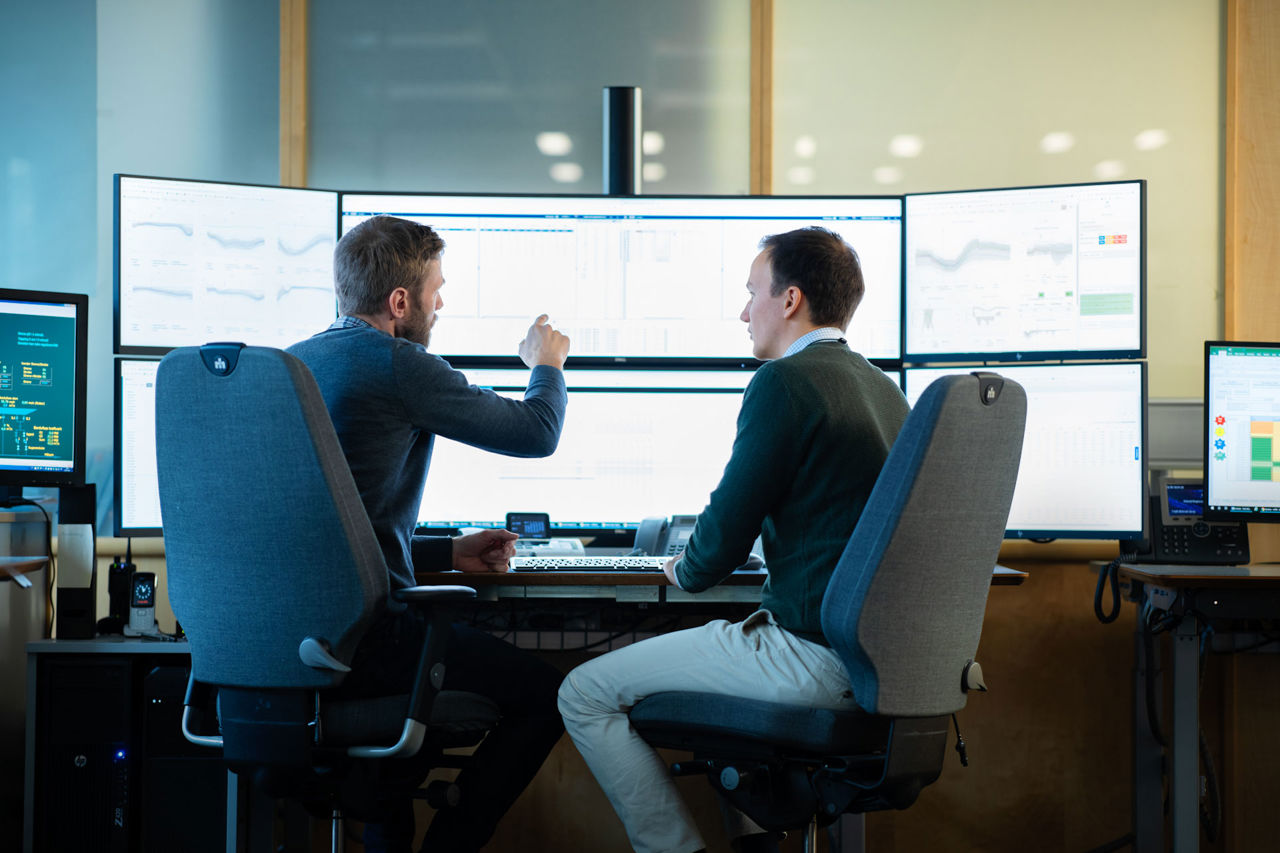 Two men in front of computers